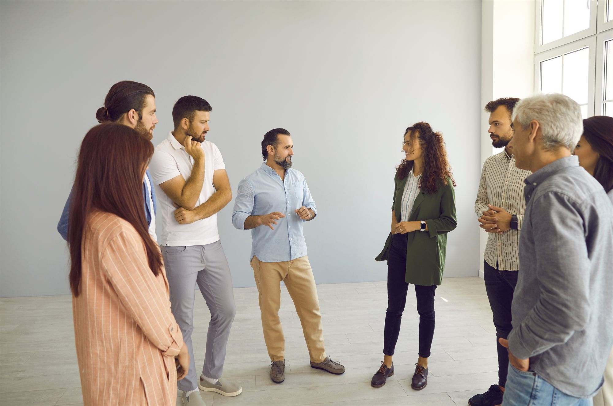 Groupe de consultants debout en discussion dans un bureau