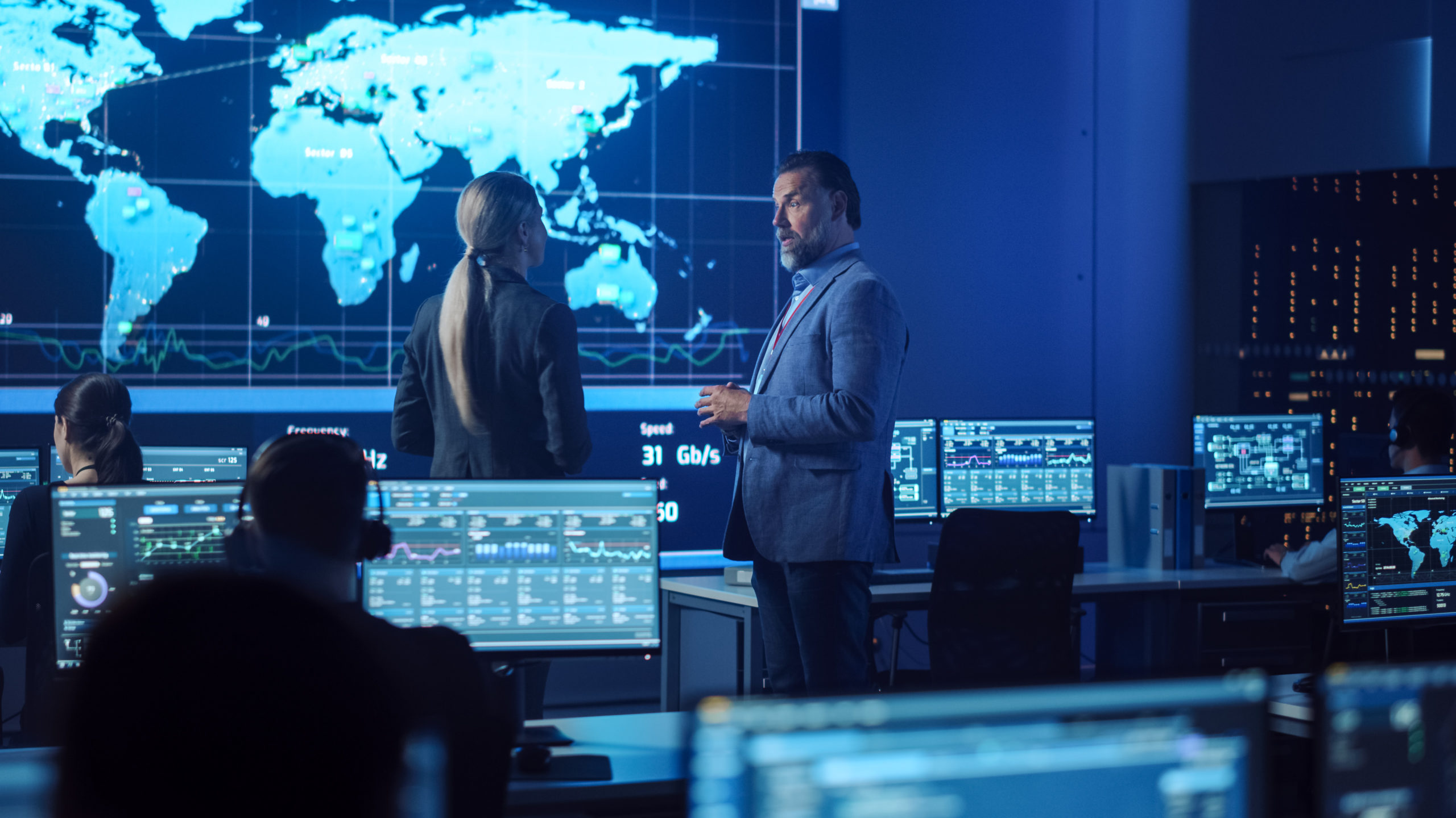 Engineers in the control room, in front of monitoring screens