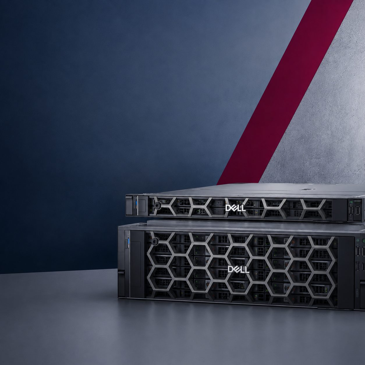 Two Dell PowerEdge rack-mount servers, stacked one on top of the other in front of a midnight blue wall